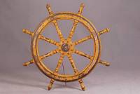 Schiffssteuerrad, 30er J., mass. Mahagoni mit Metallmontur, gelb lackiert, Speichen gedrechselt, altersbed.Lacksch., D.ca.110cm