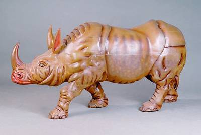 Karusell-Nashorn, Asien, ca. 70/80er Jahre, Holz geschnitzt, bunt gefaßt, Spannungsrisse, Gebrauchsspuren, ca. 70 x 150 x 35 cm