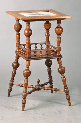 Blumentischchen, deutsch um 1880/1900, Nussbaum massiv, vielfach gedrechselt, mit Balustrade, Platte mit Jugendstilfließe, diesemit Sprung, H. ca. ...