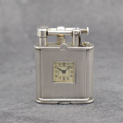 Benzinfeuerzeug mit eingelassener Uhr in 900er Silber, Schweiz um 1930, rundum guill. Geh., Front mit Scharnier aufklappbar, Boden über verg. Werk ...