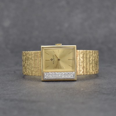 BAUME & MERCIER Damenarmbanduhr in GG 585/000, Schweiz um 1965, Handaufzug, Geh. aufw. m. Diamanten bes. zus. ca. 0,2 ct, Boden aufgedr., Goldband in ...