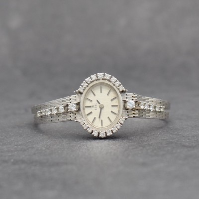 EBEL feine Damenarmbanduhr in WG 750/000 mit Brillanten, Schweiz um 1970, Handaufzug, Lünette & Bandansätze aufw. m. Brillanten bes. zus. ca. 1 ct, ...