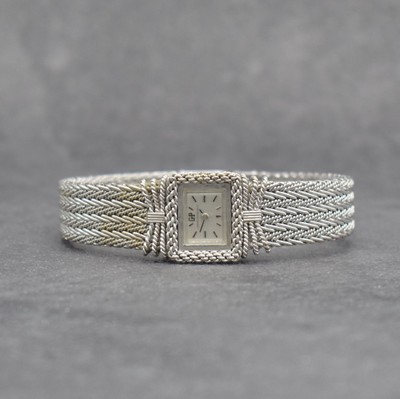 GIRARD PERREGAUX ausgefallene Damenarmbanduhr in WG 750/000, Schweiz um 1970, Handaufzug, rechteck. Geh. m. schleifen-artig geflochtener Front, silb. ...