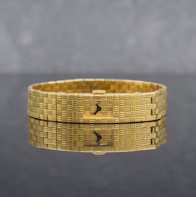 BOUCHERON feine Damenarmbanduhr in GG 750/000, Frankreich/Schweiz um 1960, Handaufzug, Schachbrettartig strukturiertes hochwertiges Gliederband und ...