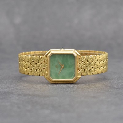 BAUME & MERCIER Damenarmbanduhr in GG 750/000, Schweiz um 1985, Handaufzug, 8-eckiges Geh., Boden aufgedr., anges. Flechtband, grünes Chinalack ...