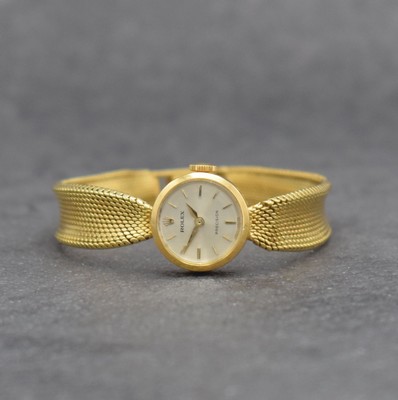 ROLEX Damengoldbanduhr in GG 750/000, Schweiz um 1950, Handaufzug, gedr. Geh., anges. Milanaiseband zum Geh. gerafft, silb. Zifferbl., gold. Indizes ...