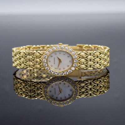 BUCHERER hochwertige mit Brillanten besetzte Damenarmbanduhr in GG 750/000, Schweiz um 1995, quarz, ovales Geh., Boden aufgedr., Lünette m. ca. 1,3 ...