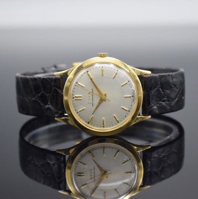 DOXA Herrenarmbanduhr in GG 750/000, Schweiz um 1960, Handaufzug, 3-teil. Geh. m. Münzranddell., Boden & Glasrand aufgedr., silb. Zifferbl. m. gold. ...