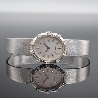 KRANEFELD Damenarmbanduhr mit Diamantbesatz in WG 585/000, Schweiz um 1970, Handaufzug, Geh. an WG 585/000 Band, Boden aufgedr., silb. Zifferbl. m. ...