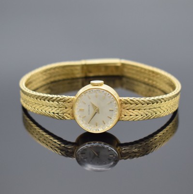 GÜBELIN Damenarmbanduhr in GG 750/000, Schweiz 1960er Jahre, Handaufzug, Boden aufgedr., GG 750/000 Armband, silb. Zifferbl. m. gold. Std.-Ind. & ...