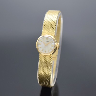ROLEX Damengoldbanduhr in GG 750/000, Schweiz um 1950, Handaufzug, Geh. an neutr. Goldband in GG 750/000, Boden aufgedr., silb. Zifferbl. m. gold. ...