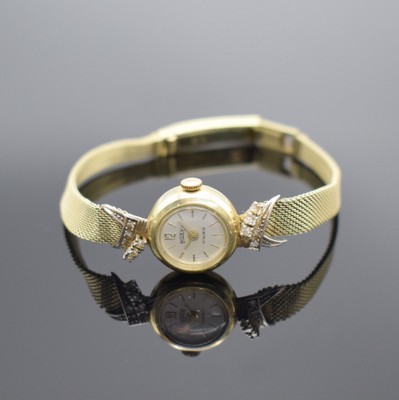 ROXY Damenarmbanduhr in GG 585/000 mit Diamanten, Schweiz um 1965, Handaufzug, Geh. an Goldband in GG 585/000, Boden aufgedr., silb. Zifferbl. m. ...
