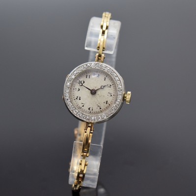 Frühe Damenarmbanduhr in GG 585/000, Schweiz um 1920, Handaufzug, 3-teil. Geh., Goldband m. Sicherheitskettchen, Lünette in WG 333/000 m. Diamanten ...
