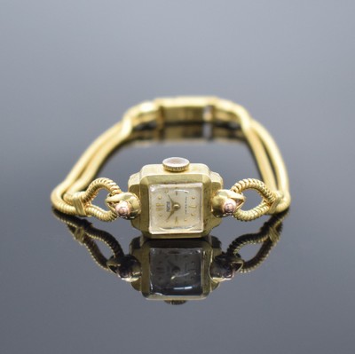 ROME Damenarmbanduhr in GG 585/000, Schweiz um 1950, Handaufzug, tropfenförm. Anstöße, Boden aufgedr., silb. Zifferbl. m. Strahlendekor, gold. ...
