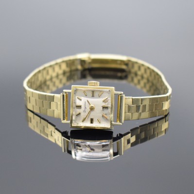 DUGENA viereckige Damenarmbanduhr in GG 585/000, Schweiz um 1965, Handaufzug, Boden aufgedr., silb. Zifferbl. l. fl., gold. Std.- Ind. & Zeiger, Kal. ...