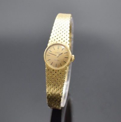 OMEGA De Ville Damenarmbanduhr in GG 750/000, Schweiz um 1969, Handaufzug, Geh. an Goldband 750/000, Boden aufgedr., goldfarb. Zifferbl. m. aufgel. ...