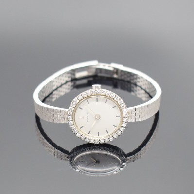 CORUM Damenarmbanduhr in WG 750/000, Schweiz um 1965, Handaufzug, Boden aufgedr., inkl. Band in WG 750/000, Lünette aufw. m. Diamanten bes. zus. ca. ...