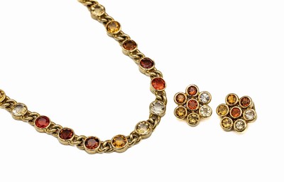 18 kt Gold Feueropal-Schmuckset, GG 750/000, best. aus: Collier L. ca. 45 cm, S - Schließe, dazu Paar blütenförm. Ohrclips, 1 Stein besch., ...