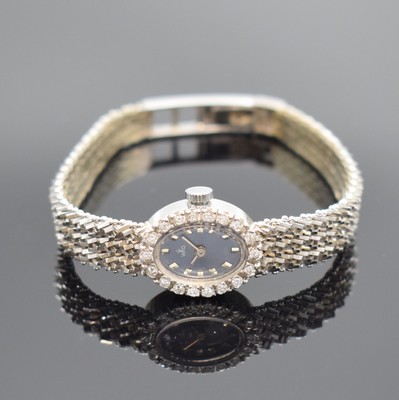 WFD Damenarmbanduhr in WG 750/000 mit Diamanten, Schweiz um 1965, Handaufzug, Boden aufgedr., Lünette aufw. m. Diamanten bes., blaues Zifferbl. m. ...