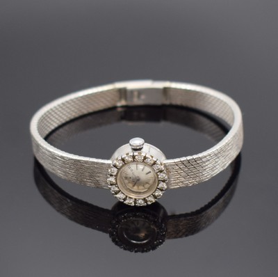 EBEL Damenarmbanduhr in WG 750/000 mit Diamanten, Schweiz um 1960, Handaufzug, Boden aufgedr., Lünette aufw. m. Diamanten bes., silb. Zifferbl. m. ...