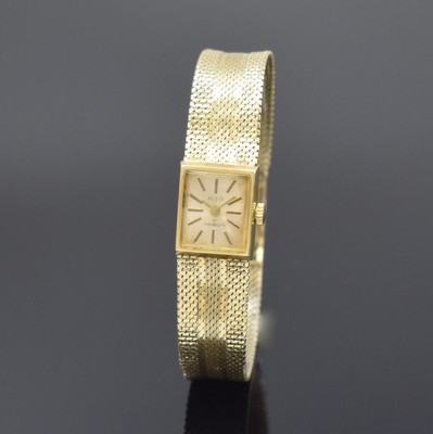 BEUCE / NIVADA Armbanduhr in GG 585/000, Schweiz um 1975, Handaufzug, Boden aufgedr., silb. Zifferbl. m. gold. Std.-Ind. altersbed. pat., gold. ...