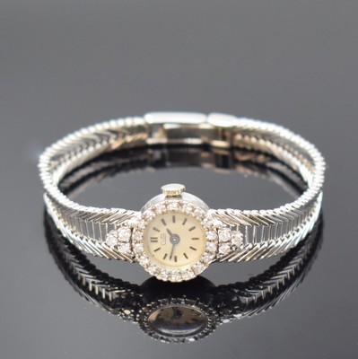 CITO Damenarmbanduhr in WG 750/000 mit Diamanten, Schweiz um 1955, Handaufzug, Boden aufgedr., Lünette aufw. m. Diamanten bes., silb. Zifferbl. m. ...