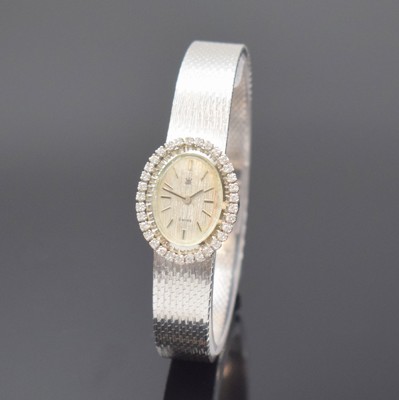 GHC Damenarmbanduhr in WG 585/000, Schweiz um 1970, Handaufzug, 2-teil. Geh., Boden aufgedr., Milanaiseband, Lünette m. Diamanten bes., silb. ...