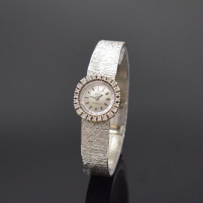 OEBRA Damenarmbanduhr in WG 585/000, Schweiz um 1970, Handaufzug, 2-teil. Gehäuse, Boden aufgedr., Milanaiseband, Lünette m. Diamanten bes., Kal. ...