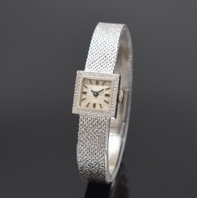 Damenarmbanduhr in WG 585/000, Schweiz um 1965, Handaufzug, 2-teil. Gehäuse, Boden aufgedr., silb. Zifferbl. m. aufges. Std.- Ind., rotverg. Werk ...