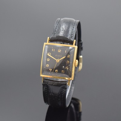 ESKA viereckige Armbanduhr in GG 750/000, Schweiz um 1955, Handaufzug, Boden m. Widmung aufgedr., schwarzes Zifferbl. rest., arab. Zahlen, gold. ...