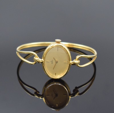 EBEL Damenarmbanduhr in GG 750/000, Handaufzug, Schweiz um 1970, neutr. 2-teil. Geh. an Goldspange, Boden aufgedr., gold. Zifferbl. m. 4 aufgel. ...