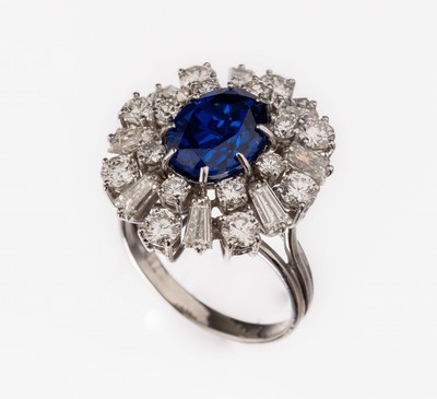 18 kt Gold Saphir-Diamant-Ring, WG 750/000,mittig ovalfacett. synth. Saphir ca. 1.80 ct, umgeben von 16 Brillanten und 8 Diamant- Trapezen zus. ca. ...