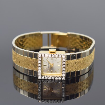 OPTINA Diamantbesetzte Damenarmbanduhr in GG/WG 750/000, Schweiz um 1965, Handaufzug, quadrat. Geh., Boden aufgedr., anges. orig. Band in WG/GG ...