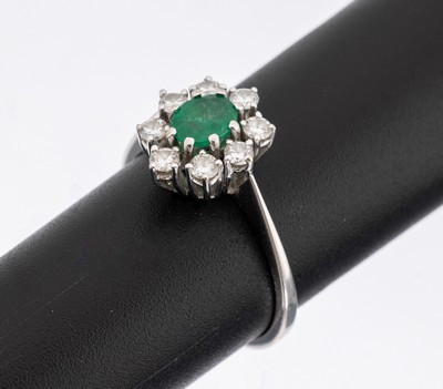 14 kt Gold Smaragd-Brillant-Ring, WG 585/000, mittig ovalfacett. Smaragd ca. 0.36 ct (grav.), umgeben von 8 Brillanten zus. ca. 0.44 ct (grav.) ...