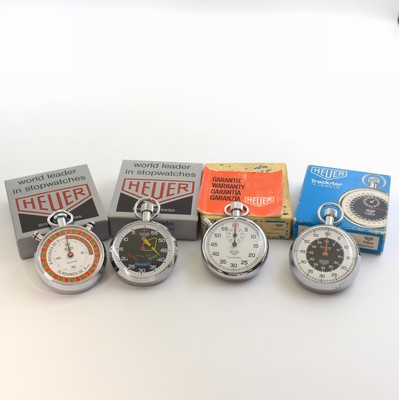 HEUER 4 nahezu neuwertige und interessante Stoppuhren in original Boxen, Schweiz um 1960/70, verchr. Gehäuse, Böden, teilw. m. orig. Stickern ...