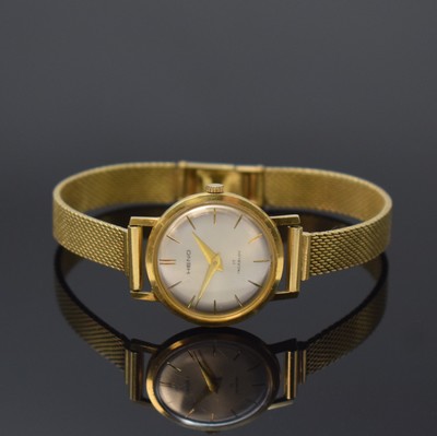 HENO Damenarmbanduhr in GG 750/000, Schweiz um 1965, Handaufzug, Glasrand aufgedr., silb. Zifferbl. m. gold. Indizes und Zeigern, D. ca. 25 mm, L. ...