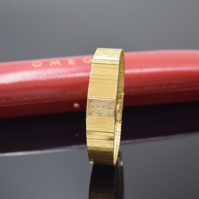 OMEGA Damenarmbanduhr in GG 750/000, Schweiz um 1965, Handaufzug, orig. Goldband, Boden aufgedr., silb. Zifferbl. fl./pat., 4 Std.- Ind., schwarze ...