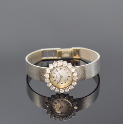 ORO Damenarmbanduhr in WG 750/000 mit Diamanten, Schweiz um 1965, Handaufzug, Goldband, Boden aufgedr., Lünette aufw. m. 18 Diamanten bes., silb. ...