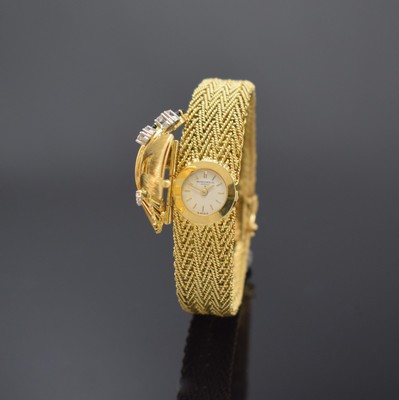 BAUME & MERCIER / ESZEHA aufwendige Damenarmbanduhr in GG 750/000, Schweiz um 1960, Handaufzug, aufklappbare Schmuckschutzkappe aufw. mit Diamanten ...