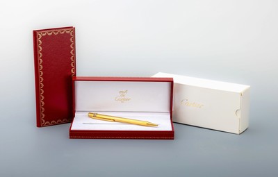 Must de CARTIER Kugelschreiber, Trinity Serie, Metall verg., geriefte Oberfläche, Drehmechanismus, orig. Etui, Papiere und Umkarton