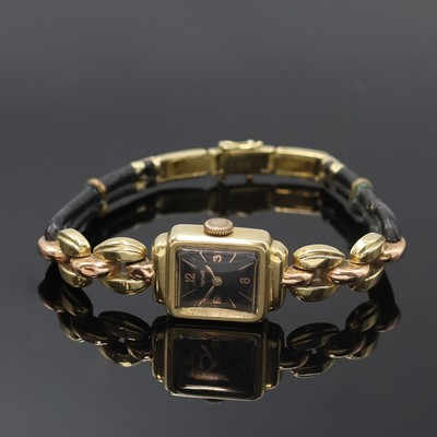 HERWALT Damenarmbanduhr in GG 585/000, Schweiz um 1955, Handaufzug, Scharnierboden, schwarzes Zifferbl. m. arab. Zahlen u. Strich-Ind., gold. Zeiger, ...