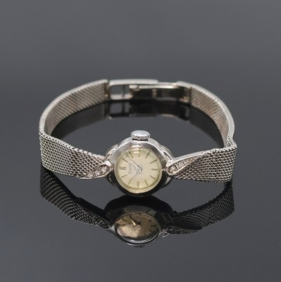 PIAGET Damenarmbanduhr in WG 585/000, Schweiz um 1960, Handaufzug, neutr. Geh. u. Band (Anstöße m. Diamanten), Boden aufgedr., silb. Zifferbl. ...