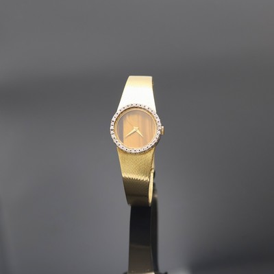 VENUS Damenarmbanduhr in GG 750/000 mit Diamantlünette, Schweiz um 1965, Handaufzug, Goldband, Boden aufgedr., Tigeraugen- Zifferbl. geriss./besch., ...