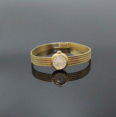 OMEGA Damenarmbanduhr in GG 750/000, Schweiz um 1960, Handaufzug, orig. Goldband, Boden aufgedr., silb. Zifferbl. m. gold. Std.-Ind. u. Zeigern, ...