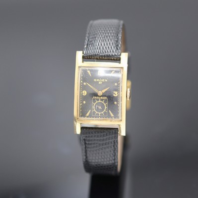 GRUEN Precision Armbanduhr in GG 585/000, USA um 1945, Handaufzug, Boden m. Monogramm aufgedr., schwarzes Zifferbl. m. arab. Zahlen u. gold. ...