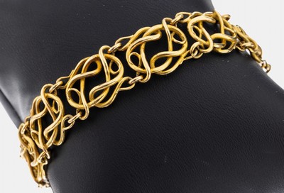 18 kt Gold Armband, GG 750/000, qualitätvolle Verarbeitung, ineinander verschlungene geschwungene Golddrähte, L. ca. 18.5 cm, Steckschließe mit ...