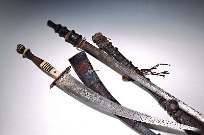 Zwei Schwerter, Nordafrika, 19./20.Jh., Säbel mit gravierter Klinge, Holzgriff mit Beinscheiben, Lederscheide, Länge 88cm; Schwert, wohl Niger, ...