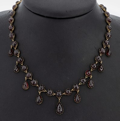 Granat-Collier, Böhmen um 1880, Tombak, rundfacett. Granate, tropfenf. Abhängungen, L.ca. 41 cm, Kastenschloss