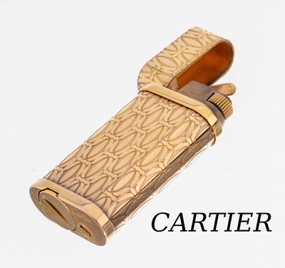 CARTIER Feuerzeug, Metall vergoldet, CC-Emblem, Fkt. ungepr., mit Anleitung in 4 Sprachen