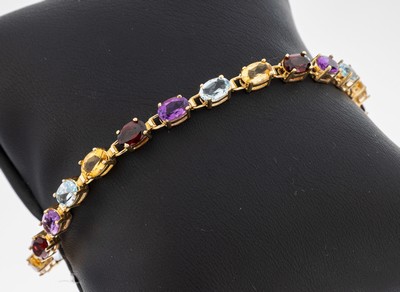 14 kt Gold Farbstein-Armband, GG 585/000, 22 ovalfacett. Farbsteine, Amethyst, Granat, Citrin und Blautopas (beh.) zus. ca. 10.0 ct, L. ca. 20 cm, ...